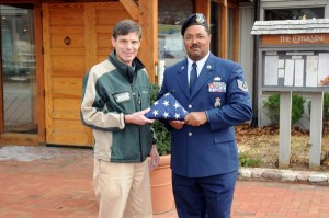 Wintergreen Resort General Manager, Hank Theiss, accepts the special flag that was flown over the military headquarters in Iraq by Alonzo.